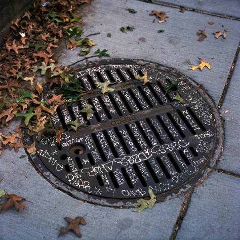 Graffiti-inscribed Manhole Cover Graffiti-inscribed Manhole Cover