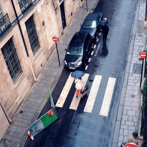 Woman Crossing Rue St. Louis in the Rain